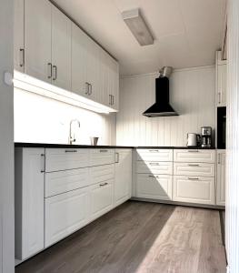 a white kitchen with white cabinets and a sink at Apartment centrally located in Bud in Bud +5 photos