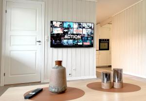 a living room with a television and a vase on a table at Apartment centrally located in Bud in Bud