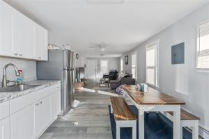 a kitchen with a table and a dining room at 404 W Maple Ave, Unit A in Wildwood