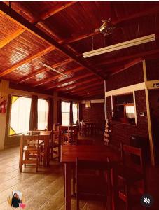 a dining room with wooden tables and chairs at Bracco in Chos Malal