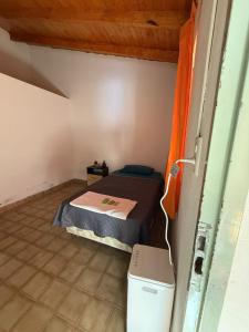 a small room with a bed and a trash can at Bracco in Chos Malal +4 photos
