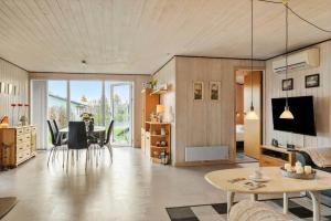 a living room with a table and a dining room at SJ316-Hejls-Ronnebaervaenget-9 in Hejlsminde