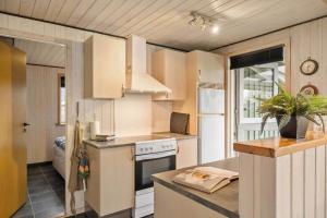 a kitchen with white cabinets and a stove at SJ316-Hejls-Ronnebaervaenget-9 in Hejlsminde