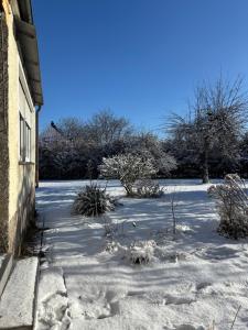 a yard covered in snow next to a building at Villa Vilma Antica in Laufen