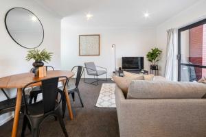 a living room with a couch and a table at Relaxed Stay in Modern Comfort - By Superior Stays in Hamilton