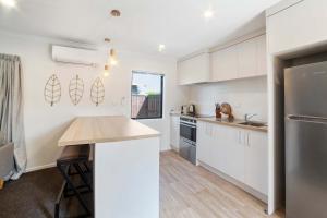 a kitchen with white cabinets and a counter top at Relaxed Stay in Modern Comfort - By Superior Stays in Hamilton