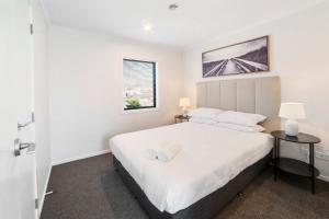 a bedroom with a large white bed and a window at Relaxed Stay in Modern Comfort - By Superior Stays in Hamilton