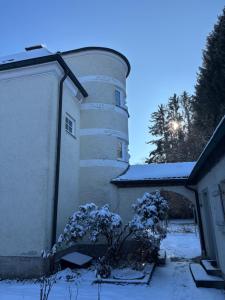 a building with a silo in the snow at Villa Vilma Antica in Laufen