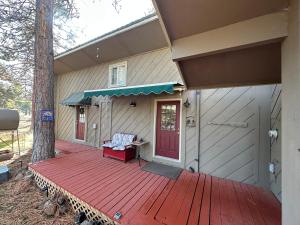 a house with a wooden deck with a red door at The Lake House in Weed