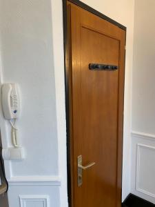 a wooden door with a phone next to it at Studio centre ville in Nevers