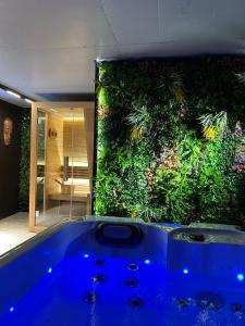 a bath tub in front of a large aquarium at Aurum Cabins in Zlatibor
