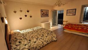 a bedroom with a bed and a dresser and a window at B&B Al Larice in Strigno