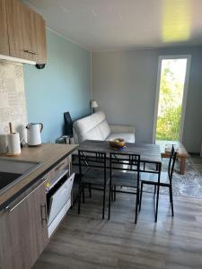 a kitchen and dining room with a table and chairs at Gîte de la Vigne in Ley