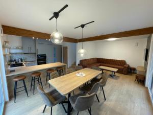 a kitchen and living room with a table and chairs at Chata-Elko Habovka in Habovka