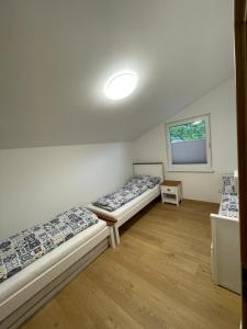 a room with two beds and a window at Chata-Elko Habovka in Habovka