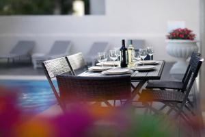 a dining table with wine bottles and glasses on it at Sintra Dream Garden Villa near Cascais in Sintra