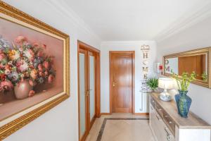 a room with a painting of flowers on the wall at Sintra Dream Garden Villa near Cascais in Sintra +44 photos