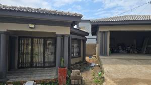 a house with a gate in front of it at HUZULA Royal Residence in Empangeni