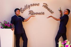 two women standing in front of a wall with a sign at Bellgrove Guest House Sandton in Johannesburg +84 photos
