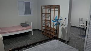 a room with a bunk bed and a room with a fan at APARTAMENTOS02 TERREO 01 quarto in Jaguaruna