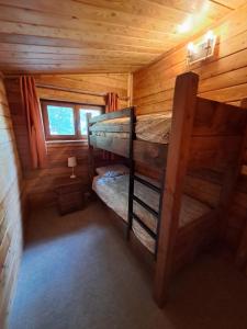a bedroom with two bunk beds in a log cabin at 87 Loch Murray in Creetown +11 photos