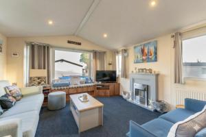 a living room with a couch and a fireplace at Captain's Quarters B67 in Brixham