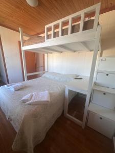 a bedroom with a bunk bed and a desk at Tu Espacio en Rada in Rada Tilly