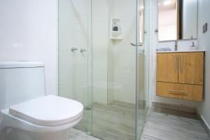a bathroom with a toilet and a glass shower at Loft 202 North Cali - Montsari in Cali