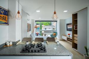 a kitchen with a counter and a living room at Loft 202 North Cali - Montsari in Cali +8 photos