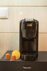 a coffee maker sitting on a counter next to a lemon at Τα πέτρινα στο Σκεπαστό in Kalavrita