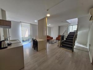 a kitchen and living room with a staircase in a house at Suiton6 apart otel in İhsaniye
