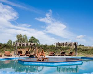 a slide in the middle of a swimming pool at El Abrazo de las Sierras in Minas +60 photos