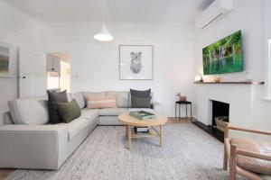 a living room with a couch and a table at The Gums, Beechworth in Beechworth