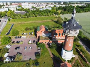 an aerial view of a building with a clock tower at Turmhotel Schwedt in Schwedt