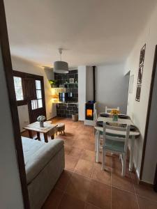 a living room with a table and a dining room at El Castaño in Guisando