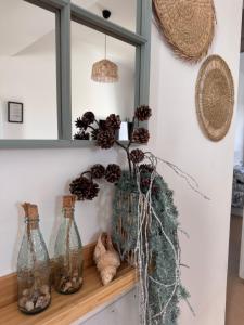 a shelf with glass bottles and pine cones on it at Rosalia28 in Antigua