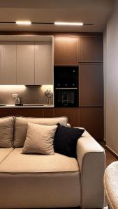 a couch in a living room with a kitchen at Luxurios seaside apartment 2 in Durrës