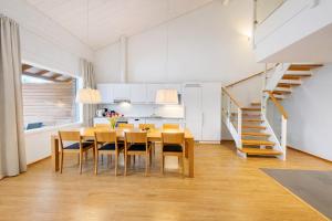 a kitchen and dining room with a table and chairs at Kylpyla Spa Villa Saimaan Harmonia in Imatra