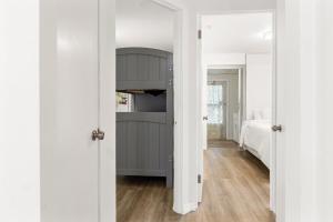 a bedroom with a door open to a bedroom with a bed at House - Minutes from Siesta Key! in Sarasota
