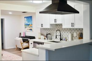 a kitchen with a sink and a stove top oven at House - Minutes from Siesta Key! in Sarasota