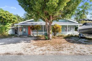 a house with a boat parked in front of it at House - Minutes from Siesta Key! in Sarasota