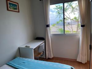 a bedroom with a bed and a desk and a window at Quarto Premium c Ar e Wi-Fi - Próximo à Ponte JK in Brasília