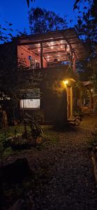 a house at night with the door open at Casa ecologica artesanal in Santa Ana
