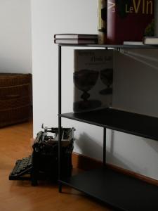 a black shelf with a camera on top of it at Le Clocher, nice warm and comfortable nest in Sierentz