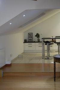 a living room with a table and a kitchen at Le Clocher, nice warm and comfortable nest in Sierentz