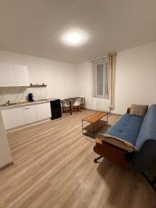 a living room with a bed and a kitchen at 4-person apartment in Joeuf