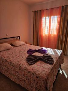 a bedroom with a bed with two bow ties on it at Golden Flow in Espargos