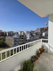 a balcony with plants and a view of a city at Golden Flow in Espargos