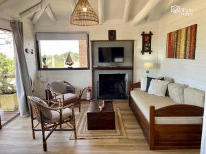 a living room with a couch and a fireplace at OHANA in Punta Del Diablo