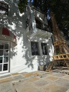 a white building with a sign on the side of it at HOSTAL PARIS TALCA in Talca